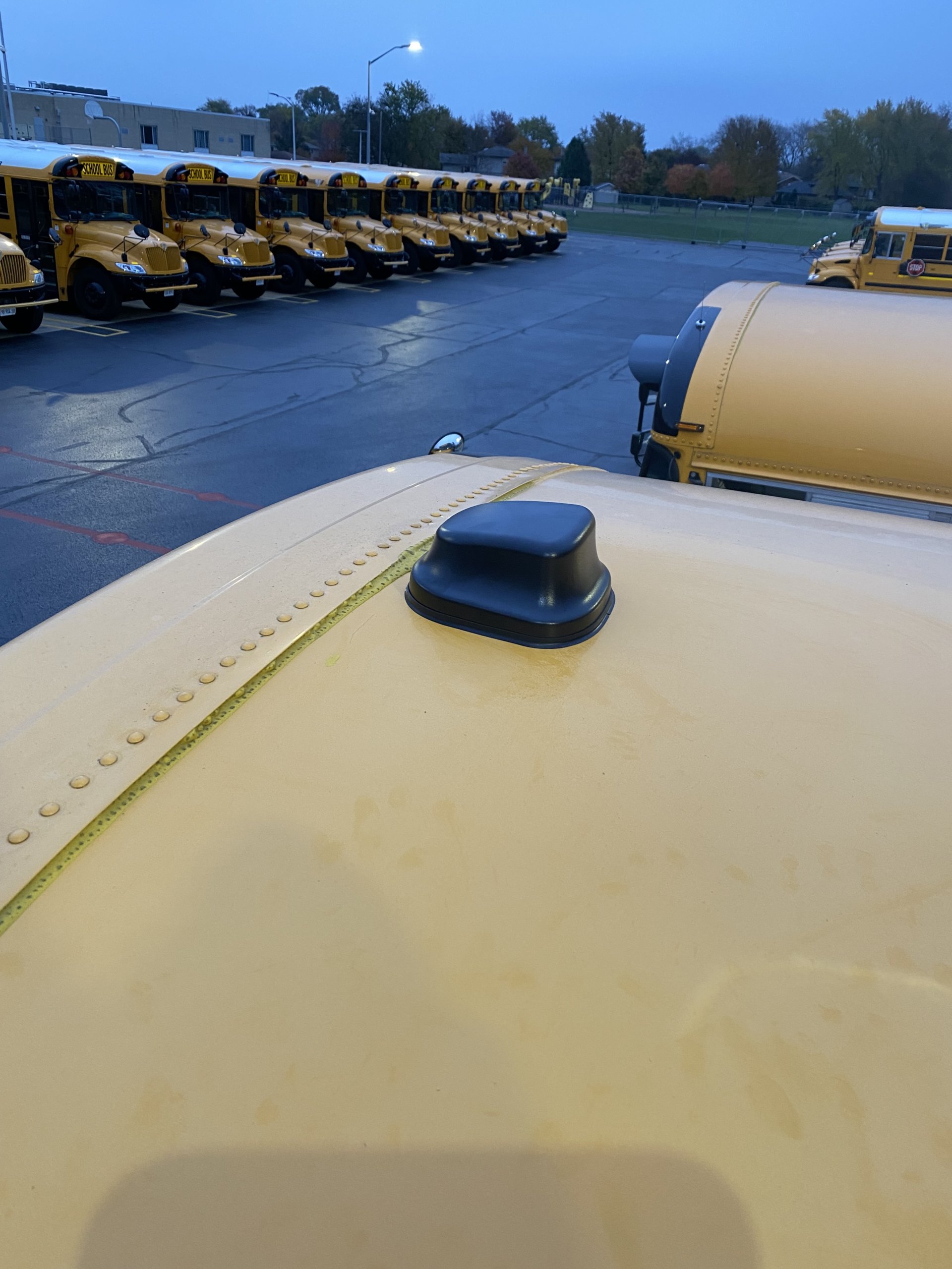 An antenna mounted on the roof of a school bus