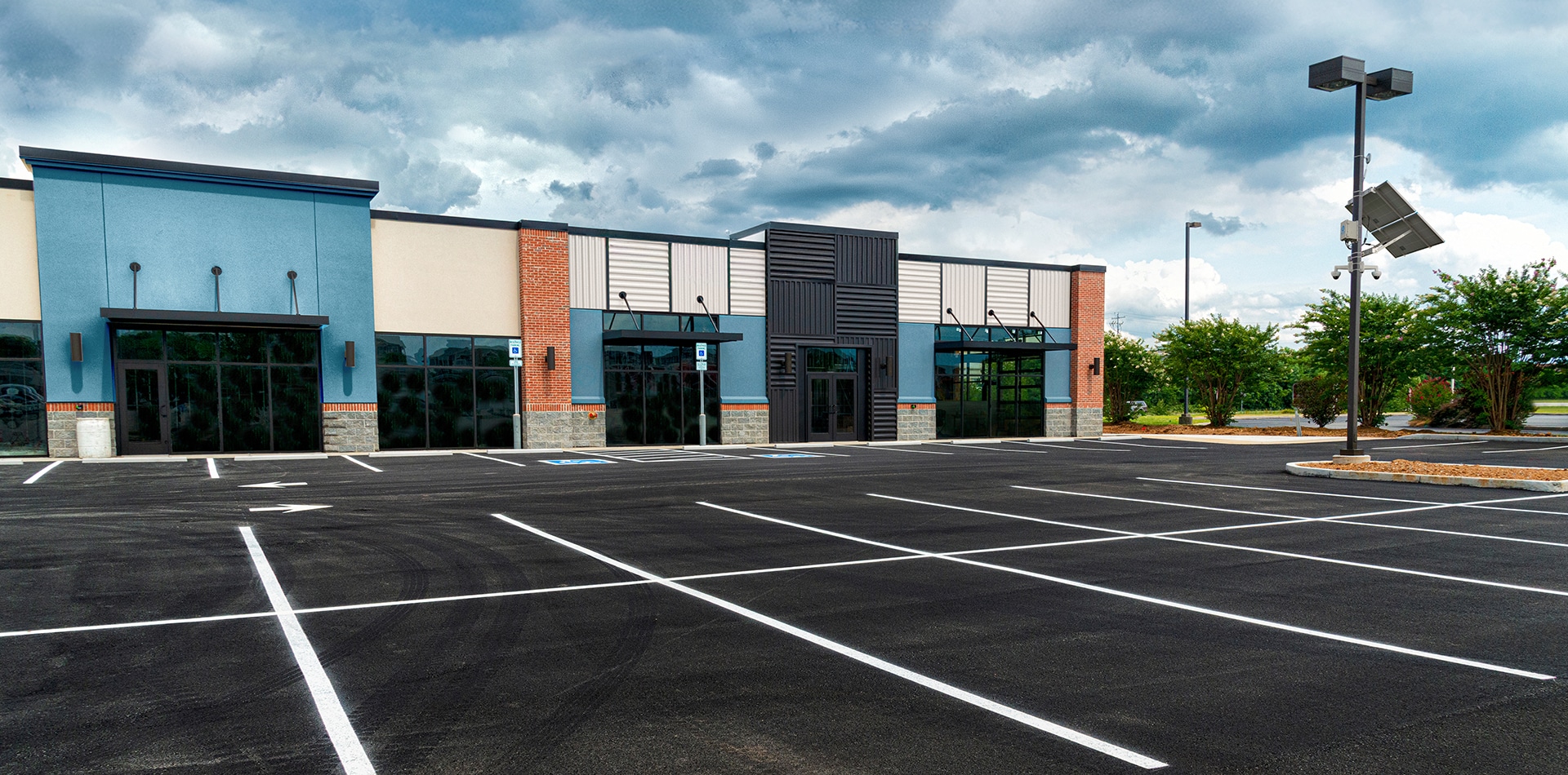 A Gridless Sentry unit, dome security cameras, and a solar panel oversee a retail store parking lot.